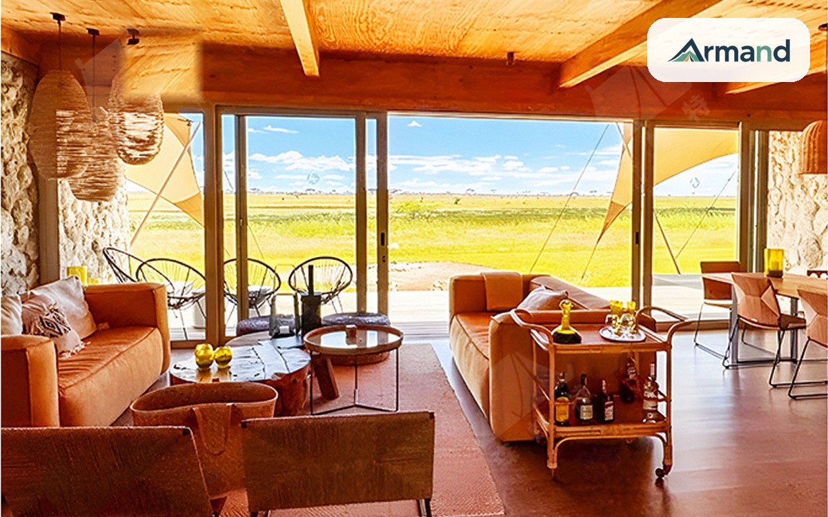 Interior of a glamping lodge tent, membrane roof over a full-width glazed wall looking out on open grassland — Armand Outdoor wholesale