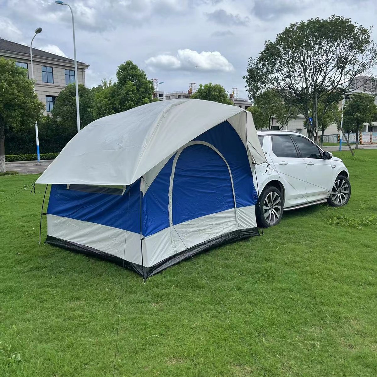 Double-layer tailgate tent in blue and grey, pitched from the rear of a vehicle — Armand Outdoor wholesale