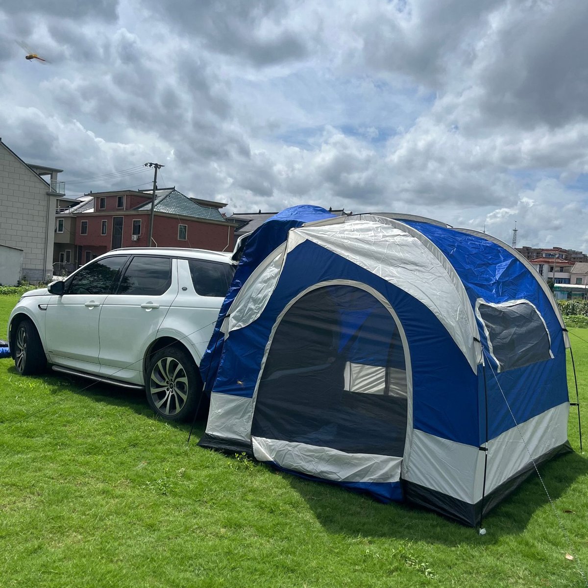 Blue and grey tailgate tent side profile with awning — Armand Outdoor wholesale
